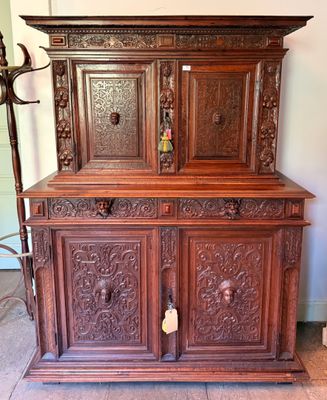 a wooden cabinet with a door and a lamp on top of it