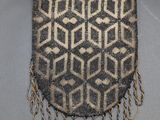 a small bag with a pattern on the front and fringes around it
