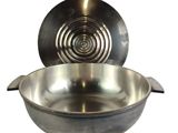 a large metal bowl with a lid and a spoon in it