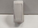 a close up of a white light switch on a wall
