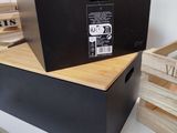 a black box with a label on it sitting on a table next to a wooden box