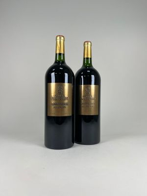 two bottles of wine sitting on top of a white table