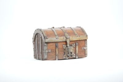 a small wooden chest on a white surface
