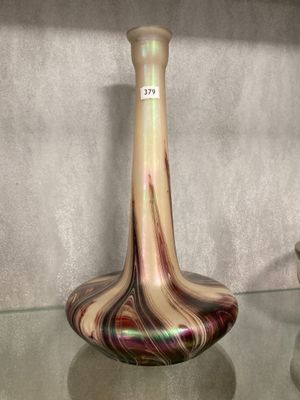 a glass table with a vase on it and two other vases