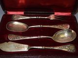 four spoons and a fork in a case
