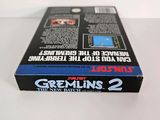 the box for the game gremlin ' s 2 is sitting on a white surface