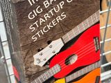 a cardboard box with a guitar sticker on top of it