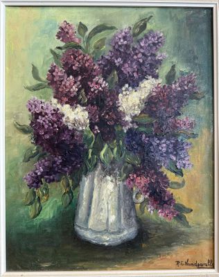 purple and white lilas in a white vase on a green background