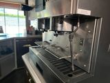 an image of a commercial coffee machine in a kitchen