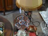 a table with a lamp, plates, and cups on it