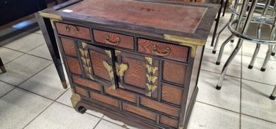 a small wooden cabinet with many drawers on it
