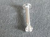 a small screw that is laying on a gray surface