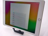 tablet computer sitting on top of a table with a colorful screen