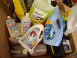 a cardboard box full of cleaning products and other household items