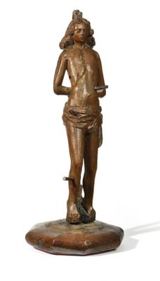 bronze statue of a woman holding a knife on a wooden base