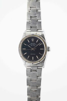 an image of a wrist watch with a black dial on a silver bracelet