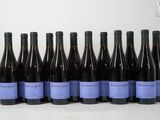 six bottles of wine are lined up in a row on a table