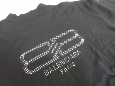 a close up of a black t shirt with a white logo on it