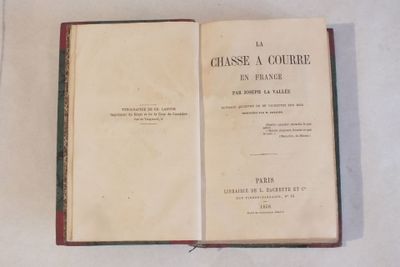 un livre ouvert posé sur une table, à côté d'une nappe blanche