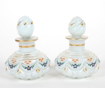 pair of white and gold vases with blue flowers on them