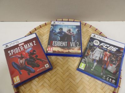 three video games sitting on a tray on a table