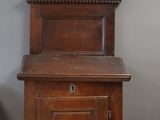 a wooden cabinet with a door on the top of it