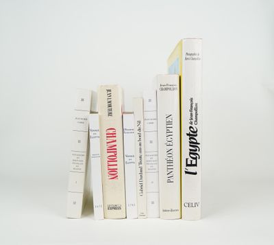 a lot of books that are stacked on top of each other