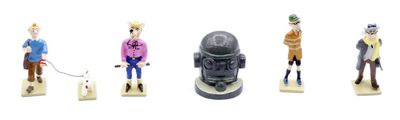 five figurines of people and a dog on a leash