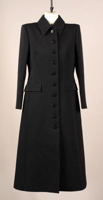 une photo d'un manteau noir sur un mannequin
