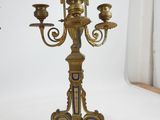 a gold candelab with three candles on it