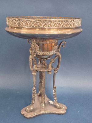 an antique silver plate with a stand on a blue background