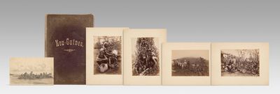 an old photo of a group of photographs of people in a field