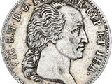 gros plan d'une pièce de monnaie sur laquelle figure un visage de femme