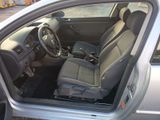 the interior of a car with the door open showing the driver ' s seat