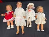 five dolls that are lined up on a black surface