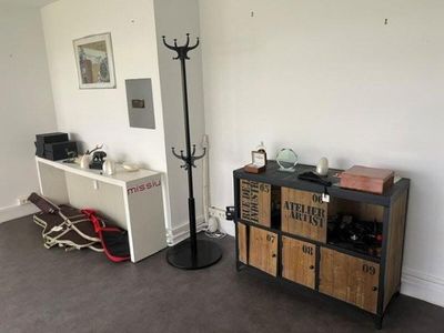 an image of a living room with a television and a coffee maker