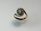 a close up of a gold ring with a diamond in the center