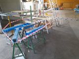 a large room with a ladder, a table, and several chairs