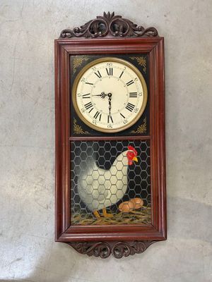 a clock on the wall with a chicken on it
