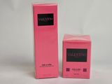 a close up of two boxes of perfume on a white surface