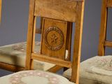 several chairs with a star and a wreath on the back of them
