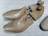 two wooden shoes that are sitting next to each other