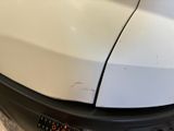 a close up of a car ' s front bumper with a denting on it