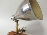 an old fashioned silver metal lamp on a wooden base