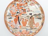a plate with a painting on it on the wall