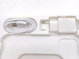a white box with a charger and a cable attached to it