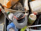 a pile of assorted items in a bin on the ground