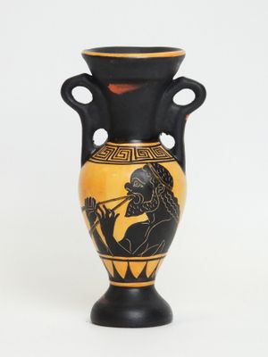 a black and yellow vase with a picture of a man playing a flute