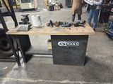 a workbench that has a lot of tools on it