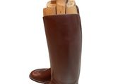 a pair of brown boots with a wooden stick in it